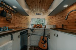 fire brown acoustic guitar on black steel stand