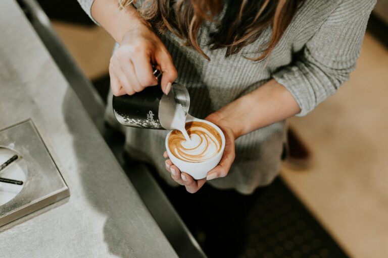 barista fire - person pouring cup of coffee in white ceramic cup